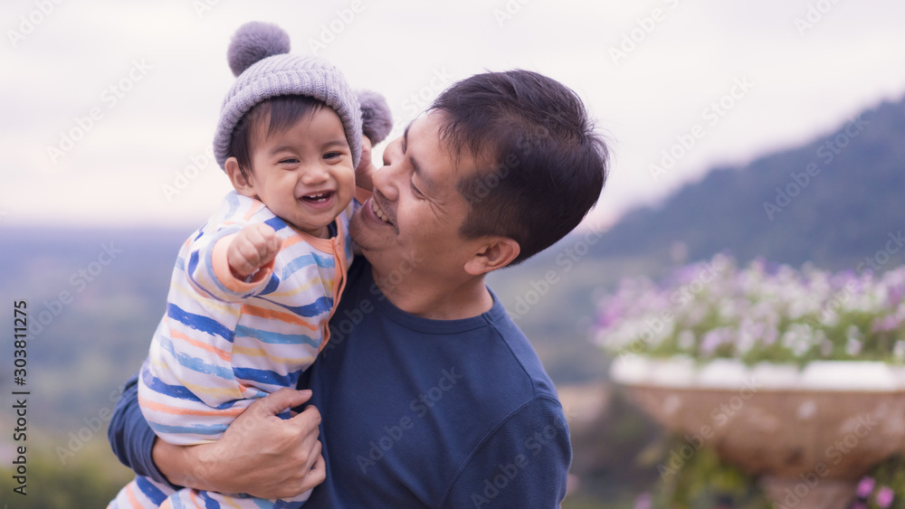 Φωτογραφία Asian father is plying with little baby boy with happiness moment on the background of nature , concept of trust love and bonding in family life