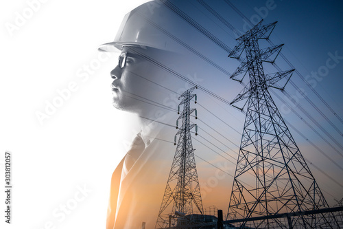 the double exposure image of the engineer thinking overlay with the high voltage pole image.  photo