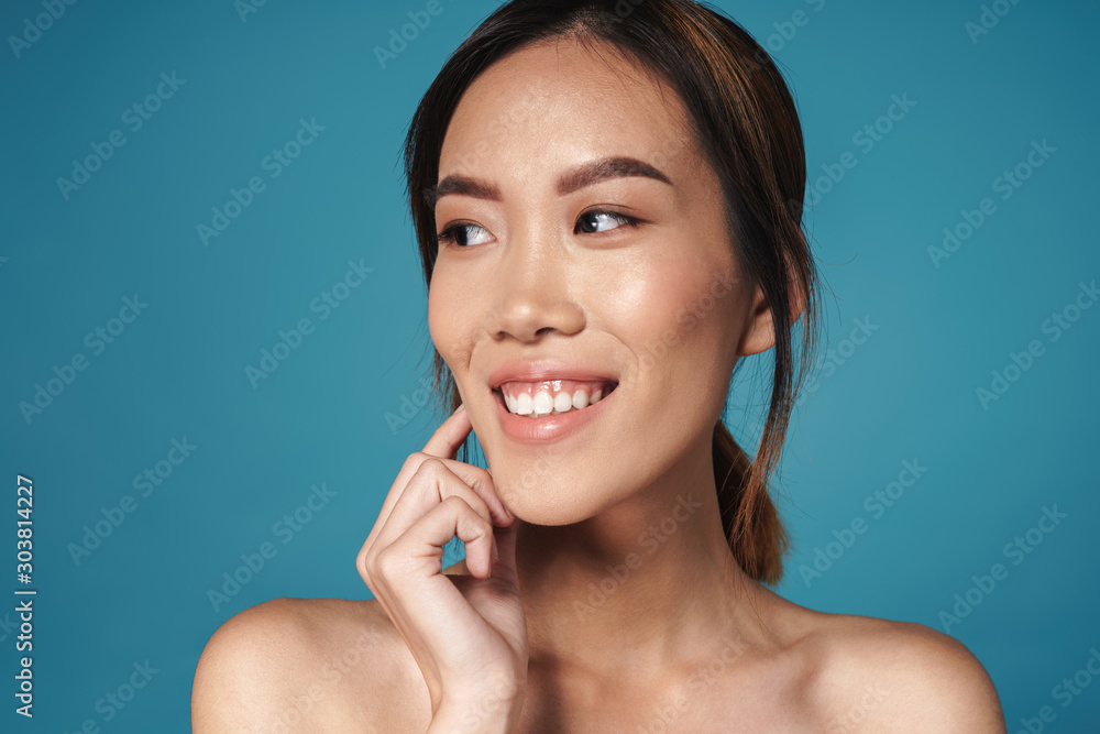 Positive smiling asian woman posing naked isolated Positive smiling asian woman posing naked isolated