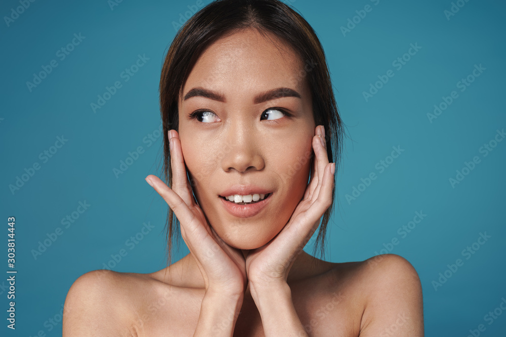 Positive smiling asian woman posing naked isolated Positive smiling asian woman posing naked isolated