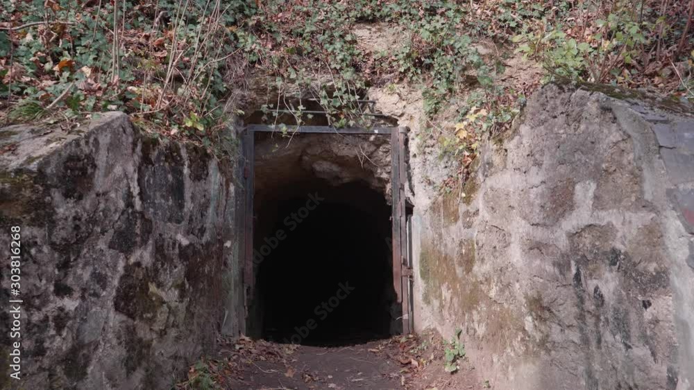 Entrance of an underground tunnel located behind the old citadel walls of Brasov, Romania. It was supposed to be used as a bunker for World Wars raids. Entrance of an underground tunnel located behind the old citadel walls of Brasov, Romania. It was supposed to be used as a bunker for World Wars raids.