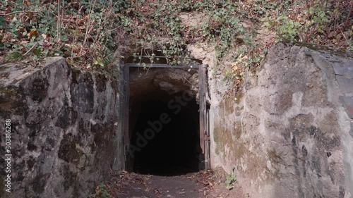 Entrance of an underground tunnel located behind the old citadel walls of Brasov, Romania. It was supposed to be used as a bunker for World Wars raids. photo