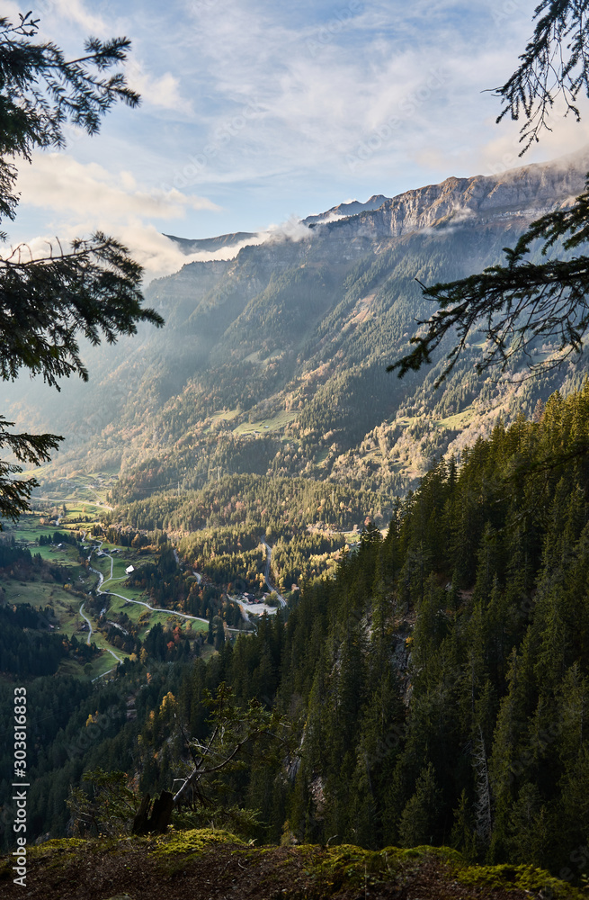 The last rays of the sun illuminate the slope of the Sätteli and the Gadmen valley, seen from the trail to the suspension bridge of Trift (Triftbrücke). Switzerland