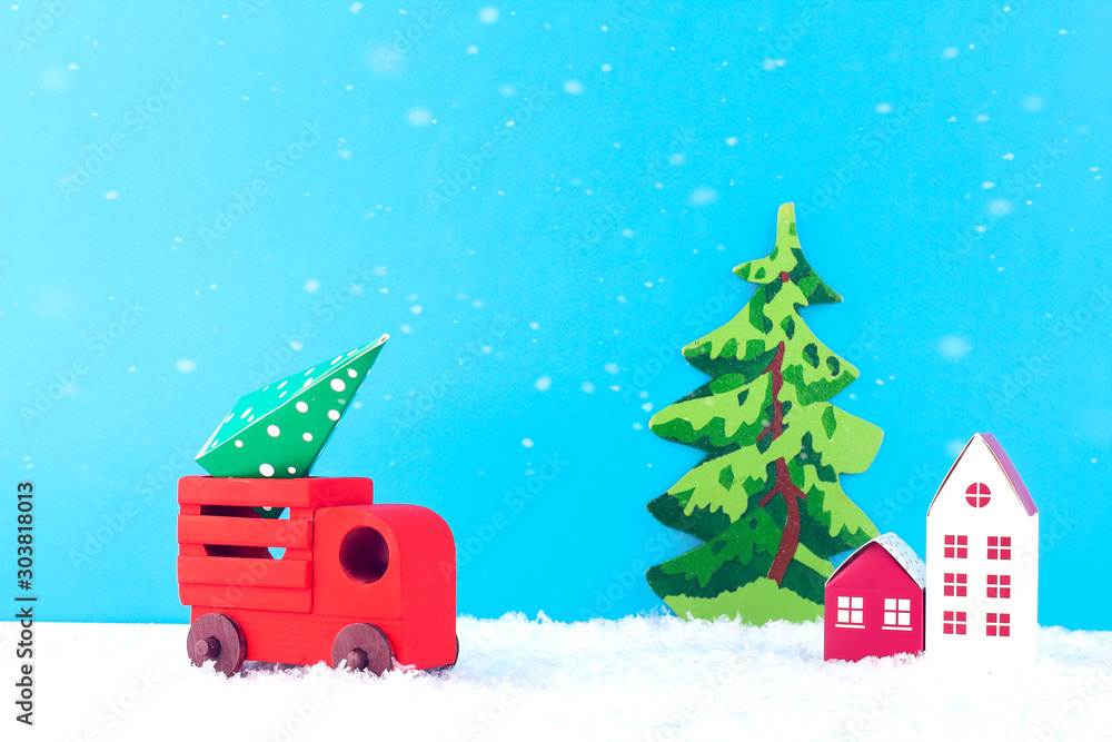 Creative christmas composition. Red car carries a Christmas tree. Paper art of Merry Christmas and New Year. Copy space.