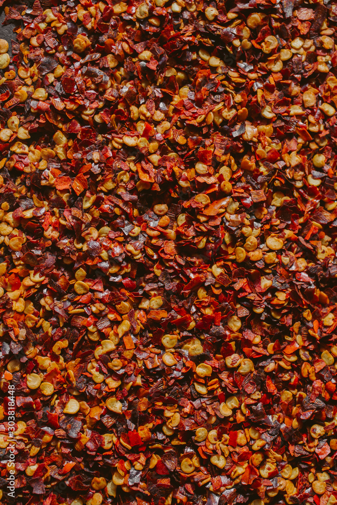Close up view of chili flakes. Dried chili flakes as background. Close up view of crushed red cayenne pepper. Top view.