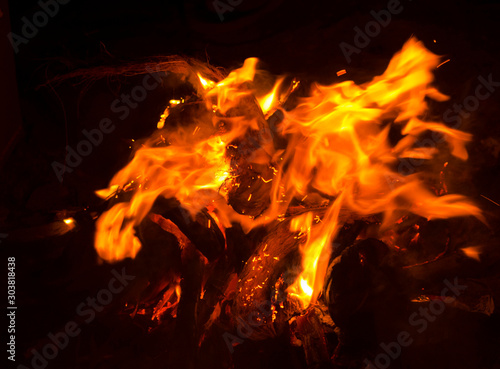 Burning wood Bonfire closeup with Red and orange flame on black background