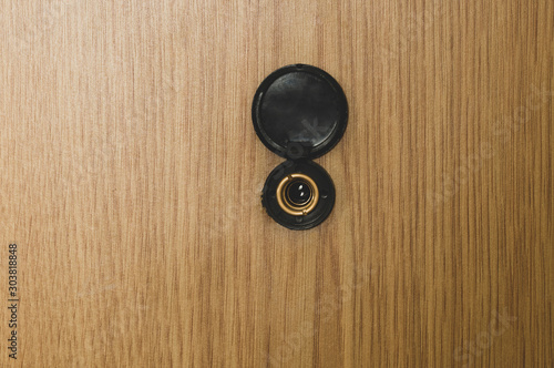 black door peephole close-up, tinted image