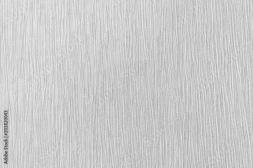 Rough white pleated relief stucco wall texture background. blank for designers