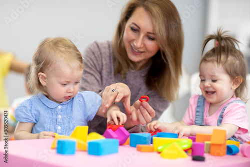 Nursery kids play with educ...