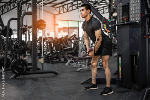 athletic man doing chest exercise using cable crossover machine gym sports fitness motivation strength concept