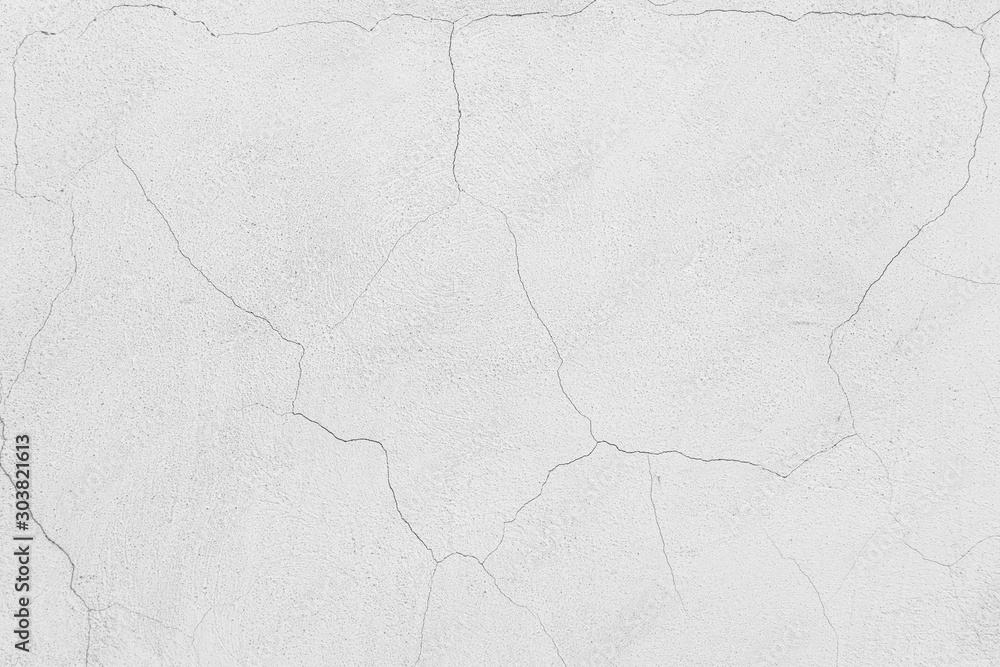 Rough white relief stucco with cracks wall texture background. blank for designers