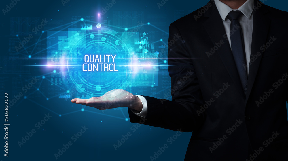 Man hand holding QUALITY CONTROL inscription, technology concept Man hand holding QUALITY CONTROL inscription, technology concept
