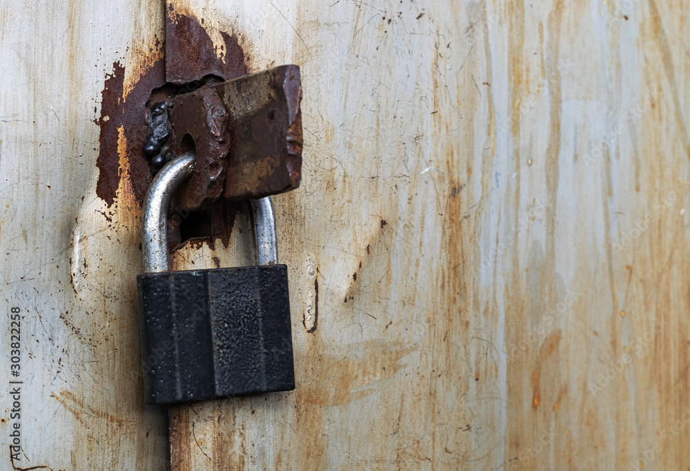 rusty old padlock for locking the large iron doors rusty old padlock for locking the large iron doors