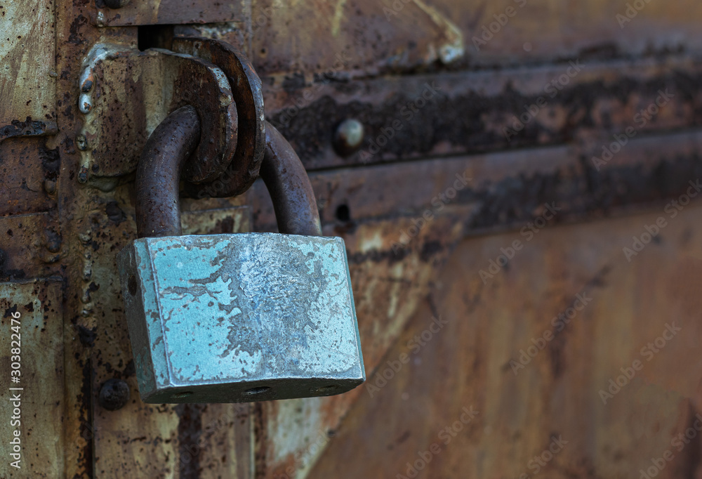 rusty old padlock for locking the large iron doors