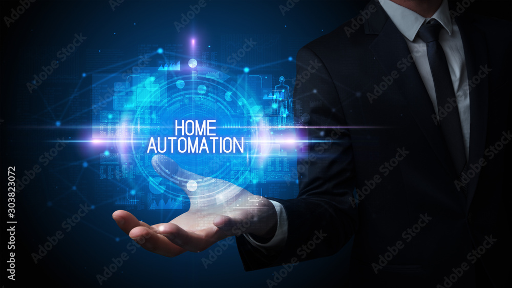 Man hand holding HOME AUTOMATION inscription, technology concept Man hand holding HOME AUTOMATION inscription, technology concept