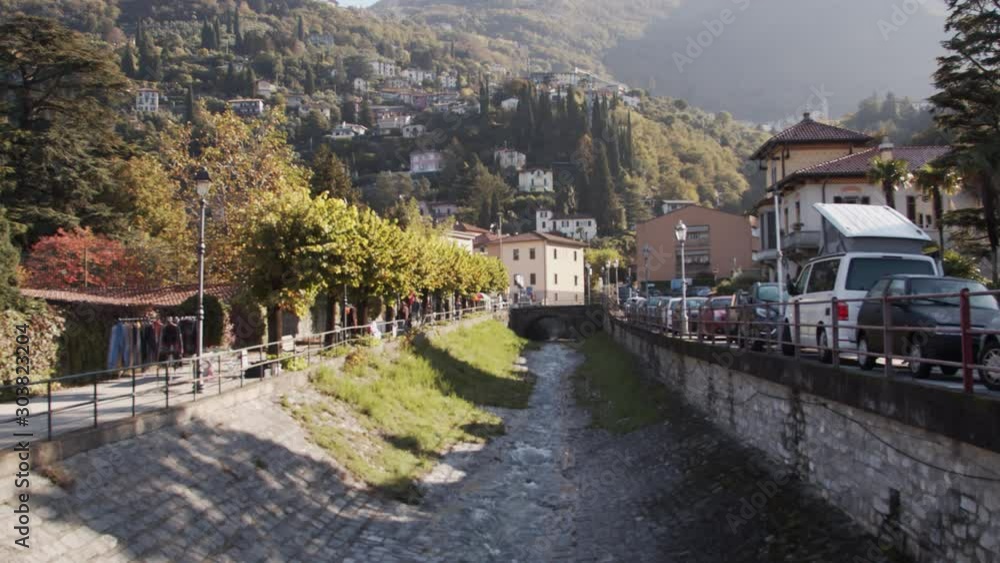 View of the town over the mountains from the stream on a sunny day, Slowmotion, Varenna, Italy. View of the town over the mountains from the stream on a sunny day, Slowmotion, Varenna, Italy.