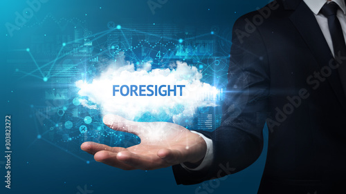 Hand of Businessman holding FORESIGHT inscription, successful business concept