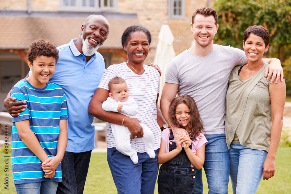 Portrait Of Smiling Multi-Generation Mixed Race Family In Garden At Home Portrait Of Smiling Multi-Generation Mixed Race Family In Garden At Home