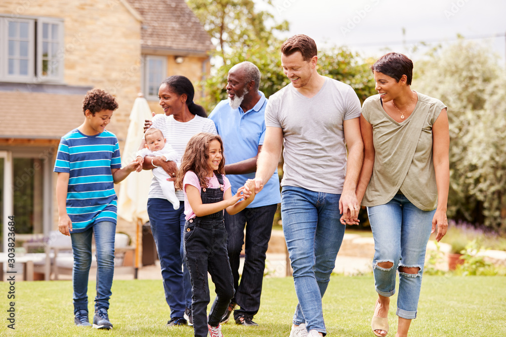 Smiling Multi-Generation Mixed Race Family In Garden At Home Together Smiling Multi-Generation Mixed Race Family In Garden At Home Together