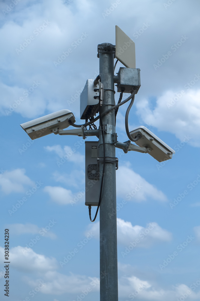 Close up of white security camera and white sky Close up of white security camera and white sky