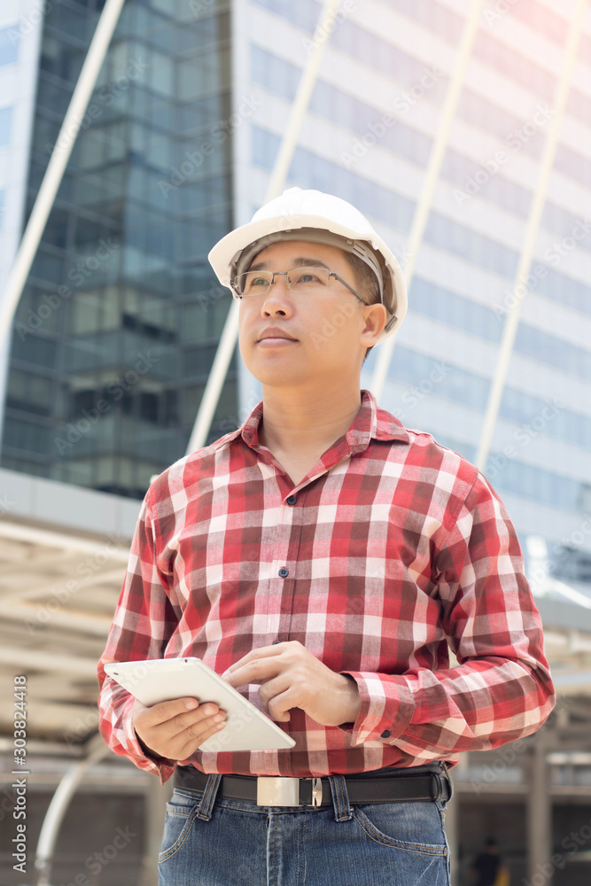 Foreman construction engineer checking on tablet in city center, Concept building construction. Foreman construction engineer checking on tablet in city center, Concept building construction.
