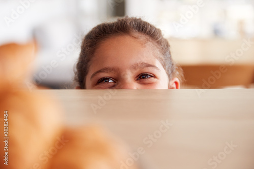 Fényképezés Mischievous Girl Wearing School Uniform Taking Croissant From Kitchen Counter