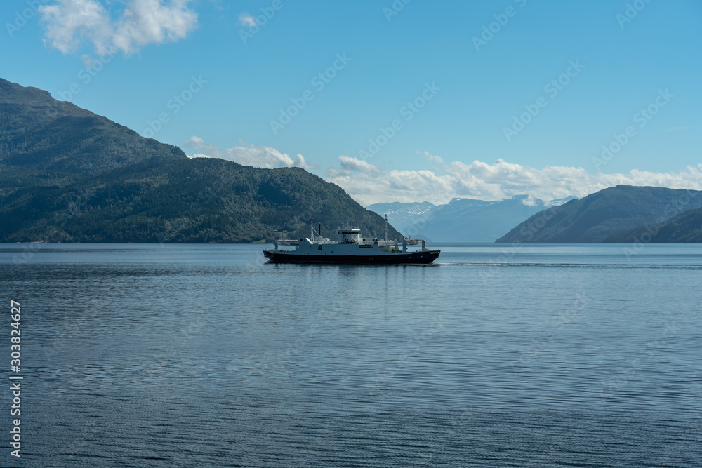 Ferry crossing a fjord in Norway on a sunny summer day