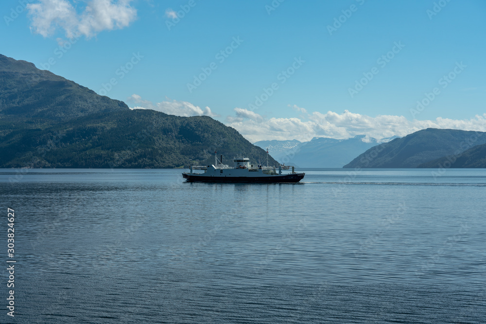 Ferry crossing a fjord in Norway on a sunny summer day Ferry crossing a fjord in Norway on a sunny summer day
