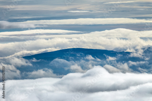 Landscape with peaks of hills in the clouds. © Viliam