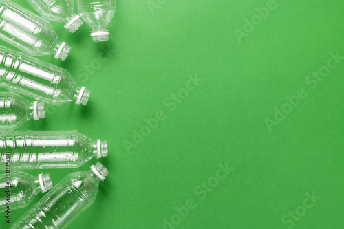 Composition of plastic waste pollution. Sorting and recycling. Disposable plastic bottles for water. Ecological concept. Flat lay, top view, copy space.