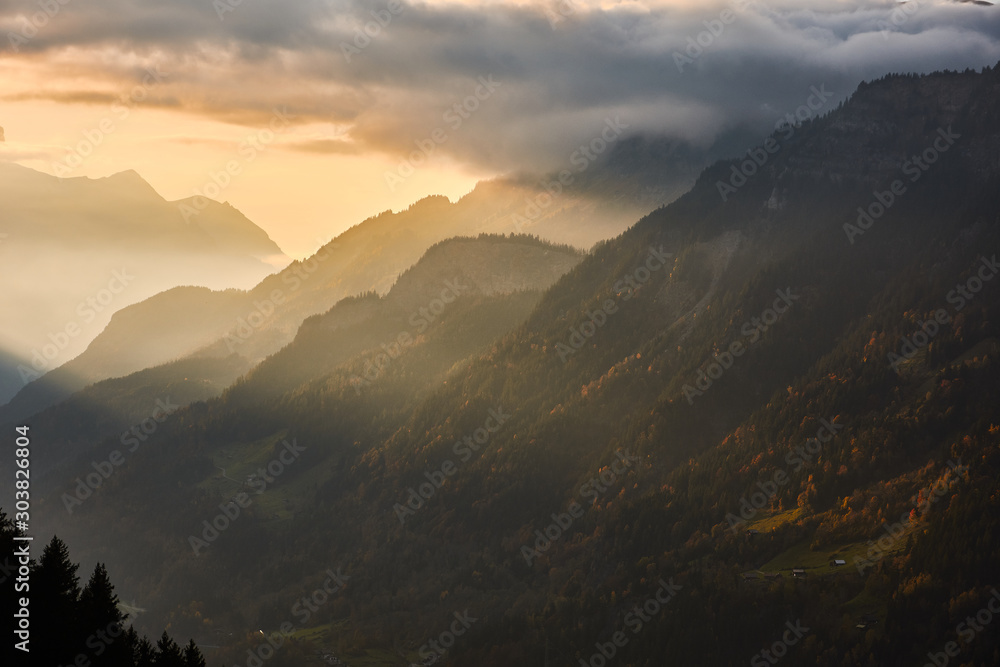 The last rays of the sun illuminate the slope of the Sätteli and the Gadmen valley, seen from the road to the suspension bridge of Trift (Triftbrücke). Switzerland