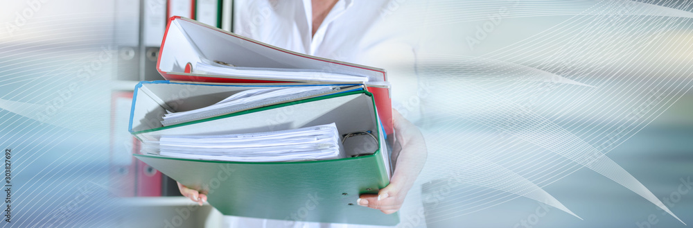 Businesswoman holding binders; panoramic banner Businesswoman holding binders; panoramic banner