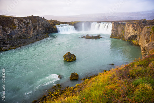 Godafoss waterfall in sunny autumn day, Iceland. Famous tourist attraction of North Iceland.