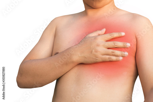 Young man suffering pain on his chest angina or even heart burn possibly symptoms of heart attack.
