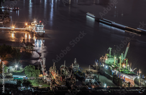 Beautiful view night of Chao Phraya River, Seen Multiple transport ships moored in the Chao Phraya River in the night, making the city modern style. 