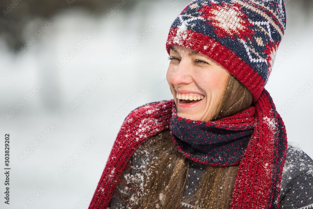 Happy beautiful woman having fun with snow outdoors in winter scenery Happy beautiful woman having fun with snow outdoors in winter scenery