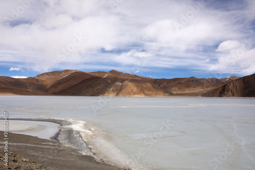 View landscape with Himalayas mountains and Pangong Tso high grassland lake while winter season for indian and tibetan and foreigner travelers travel visit at Leh Ladakh in Jammu and Kashmir, India