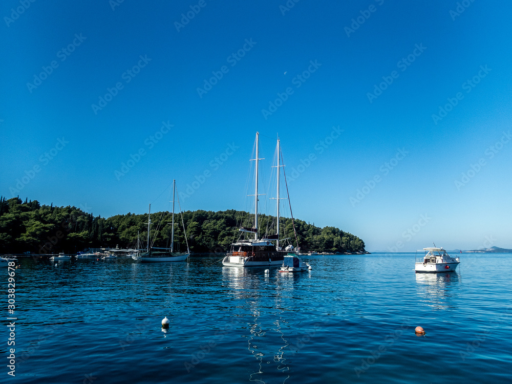 Sailboats moored in the calm sea