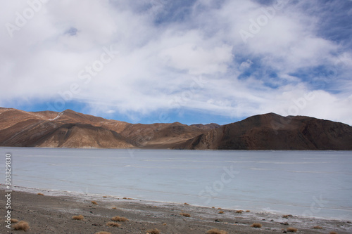 View landscape with Himalayas mountains and Pangong Tso high grassland lake while winter season for indian and tibetan and foreigner travelers travel visit at Leh Ladakh in Jammu and Kashmir, India