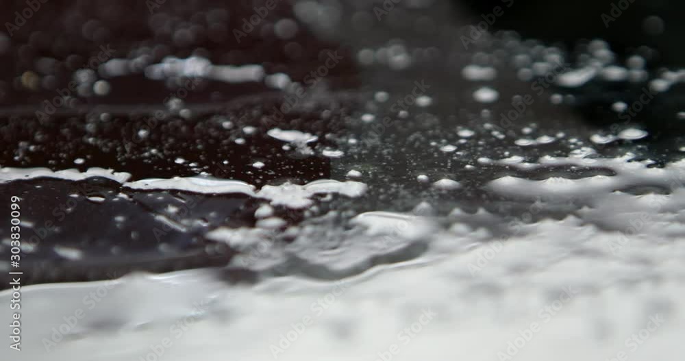 Liquid water spilled on a black background, large shot Liquid water spilled on a black background, large shot