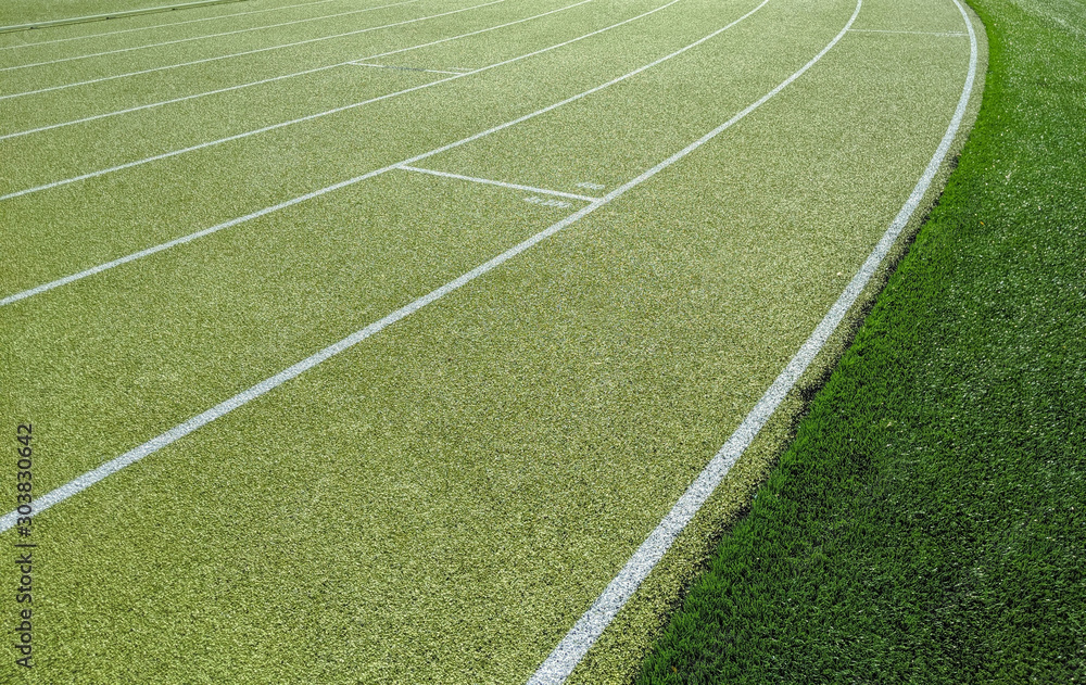 Obraz premium Green running track on athletic stadium