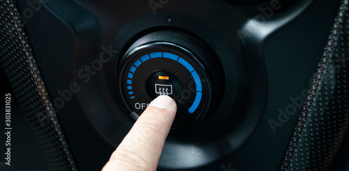 Finger pressing car defrost button