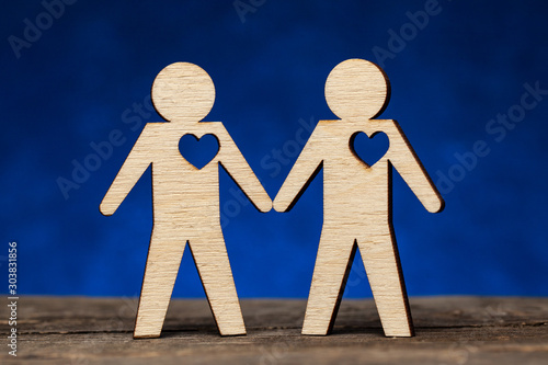 Gay couple. Two figures of men hold hands