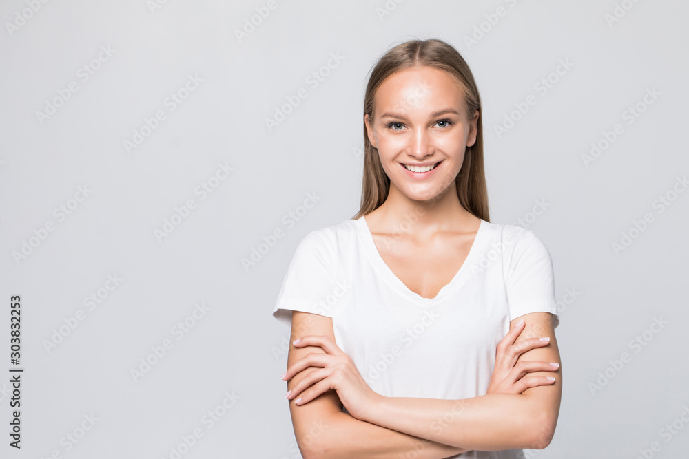Beautful happy woman standing with arms folded isolated on a white background. Looking at camera Beautful happy woman standing with arms folded isolated on a white background. Looking at camera