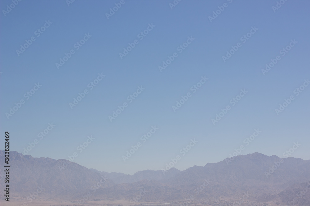 abstract wallpaper minimalism landscape of mountain ridge silhouette in morning fog blue sky simple background empty copy space for your text here  