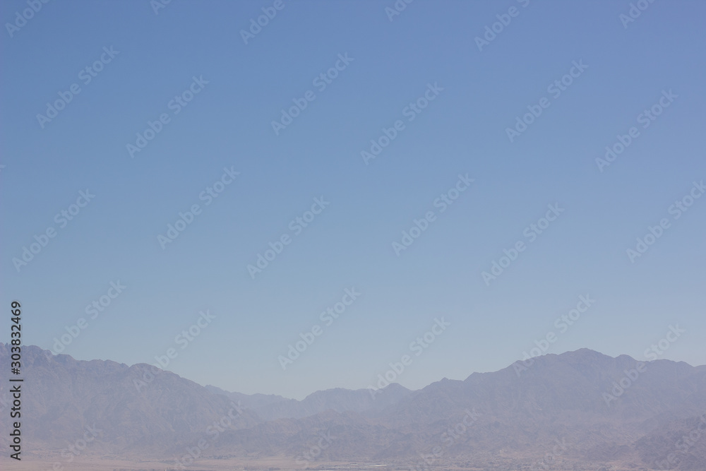 Fototapeta premium abstract wallpaper minimalism landscape of mountain ridge silhouette in morning fog blue sky simple background empty copy space for your text here 