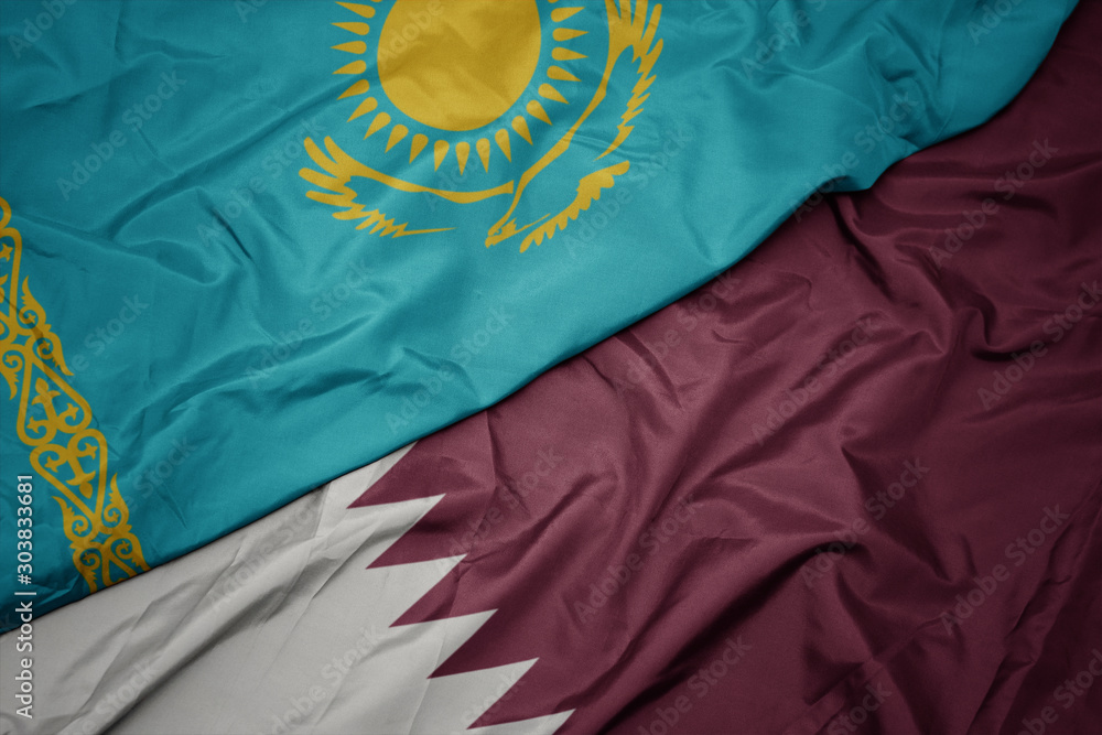 waving colorful flag of qatar and national flag of kazakhstan.