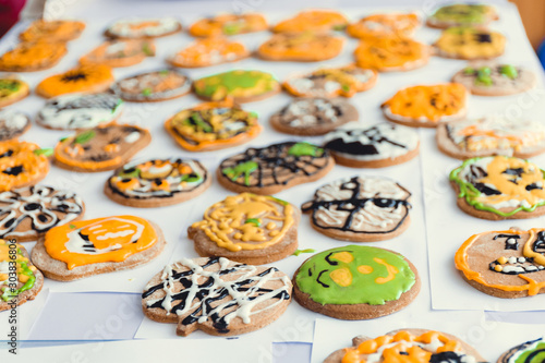 Assorted Hallowen cookies on yellow background. Halloween holiday sugar biscuits including pumpkin, bat and Jack Skellington with copy space.