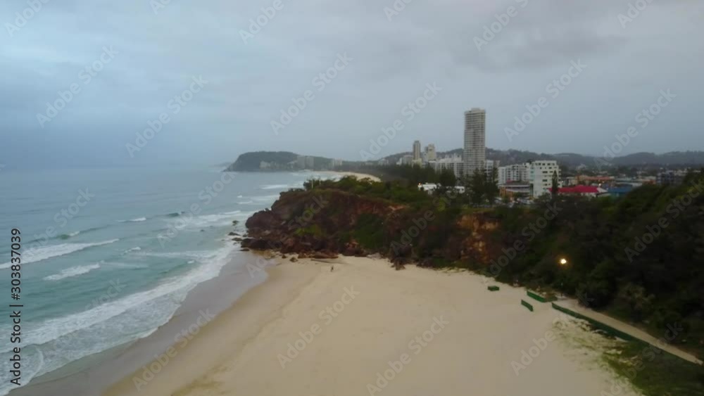 Aerial Drone Panning Towards Miami Headland Gold Coast On An Overcast Day At The Beach With Blue Crashing Waves Aerial Drone Panning Towards Miami Headland Gold Coast On An Overcast Day At The Beach With Blue Crashing Waves