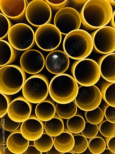 The difference sizes of yellow plastic pipes are in the construction area.
